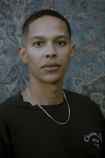Portrait of Sxdated wearing a black shirt and silver chain