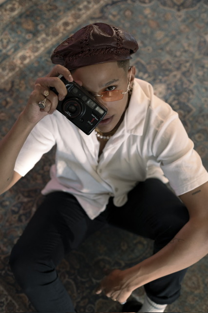 Sxdated with camera, white shirt and hat